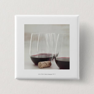 Red wine in stemless glasses 2 inch square button