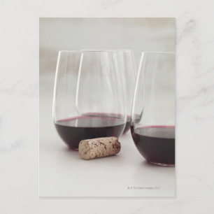Red wine in stemless glasses postcard