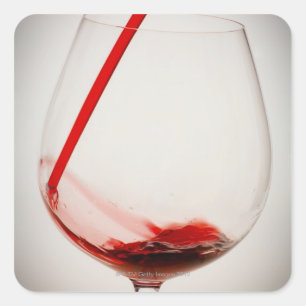 Red wine pouring into glass, close-up square sticker