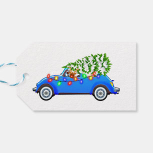 Reindeer driving a beetle with christmas treeb gift tags