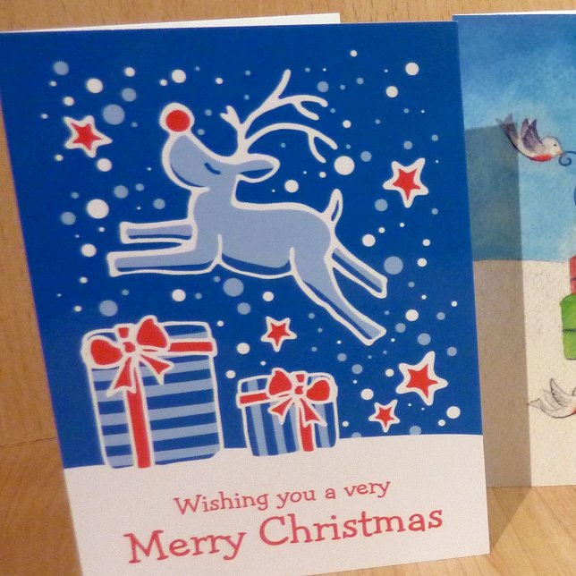 Reindeer prancing over gifts blue Christmas card (Creator Uploaded)