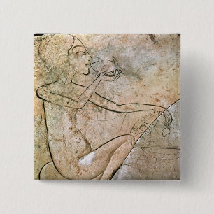 Relief depicing a princess eating a roasted 2 inch square button