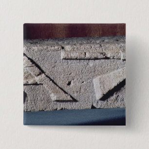 Relief depicting a stonemason's instrument 2 inch square button