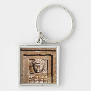 Relief depicting a woman at a window keychain