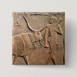 Relief depicting peasant leading cow to 2 inch square button
