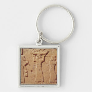 Relief depicting porters laden with gifts keychain