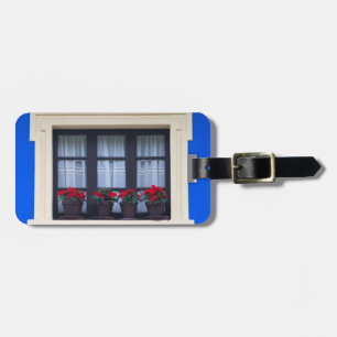 Residential housing with flowers in windows luggage tag