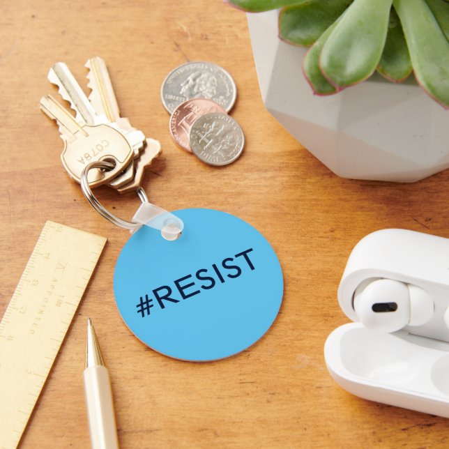 #Resist, black text on sky blue keychain (Desk)