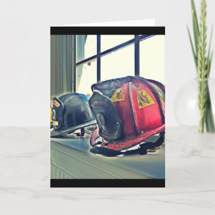 Retired fire helmets line the window card