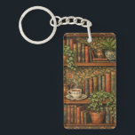 Retro book lover art keychain<br><div class="desc">A cozy retro-inspired design featuring a charming bookshelf filled with vintage books,  delicate botanical accents,   and a comforting cup of tea or coffee.</div>