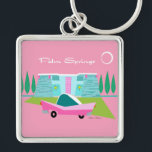 Retro Pink Palm Springs Button Keychain<br><div class="desc">Between the pink background, turquoise mid century modern home, and the classic 1950s car, this design couldn’t be more Palm Springs if it said it in the clouds. Oh, wait, it does say it in the clouds! The blue and teal stone of the house is offset by the sputnik light...</div>