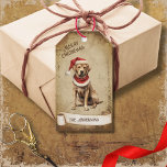 Retro Vintage Dog with Red Christmas Hat Gift Tags<br><div class="desc">Beautiful retro vintage illustration of a dog wearing a red Christmas hat on a retro grunge background and frame for an aged or vintage look. Design features a vintage scroll ribbon for your personalization both in the front or the back sides of this elegant,  and timeless Holiday Gift Tag.</div>