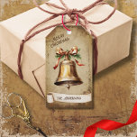 Retro Vintage Gold Brass Bell Merry Christmas Gift Tags<br><div class="desc">Beautiful retro vintage illustration of a gold brass bell decorated with a golden bow on a retro grunge background and frame for an aged or vintage look. Design features a vintage scroll ribbon for your personalization both in the front or the back sides of this elegant, and timeless Holiday Gift...</div>