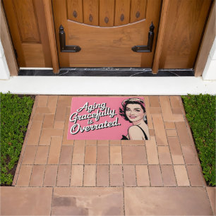 Retro Woman with "Aging Gracefully is Overrated" Doormat