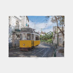 Retro yellow tram on street in Lisbon, Portugal Fleece Blanket