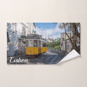 Retro yellow tram on street in Lisbon, Portugal Hand Towel