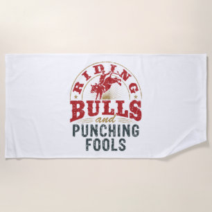 Riding Bulls and Punching Fools Beach Towel