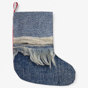 Ripped jeans texture, stylish background. small christmas stocking
