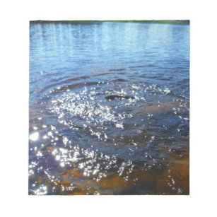 Ripples in a lake, from a fish jumping notepad