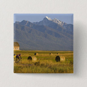 Road bicyclists race down back country road in 2 inch square button