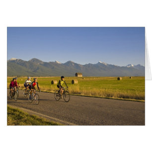 Road bicyclists ride down a back country road