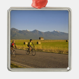Road bicyclists ride down a back country road metal ornament