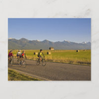 Road bicyclists ride down a back country road