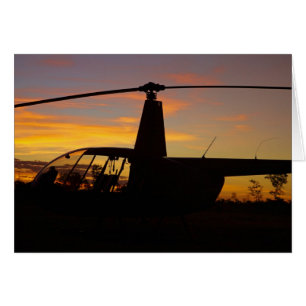 Robinson R44 helicopter at sunset
