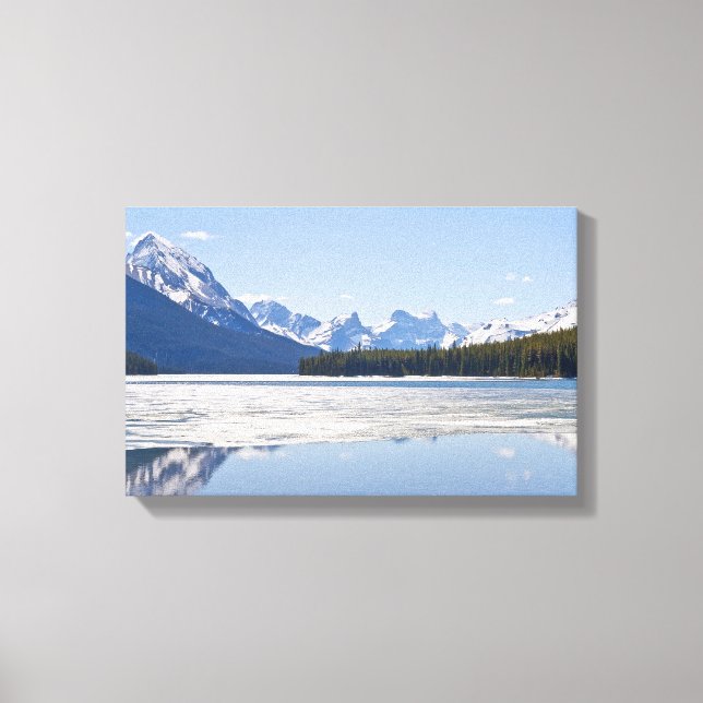 Rocky mountains reflecting in Maligne lake Canvas Print (Front)