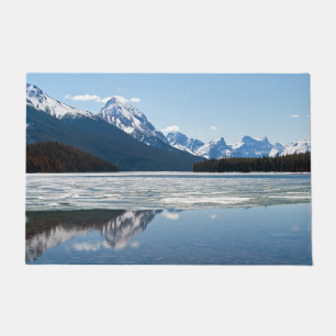 Rocky mountains reflecting in Maligne lake Doormat