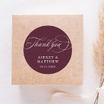 Romantic Calligraphy Burgundy Wedding Thank You Classic Round Sticker<br><div class="desc">This burgundy and white thank you wedding sticker featuring elegant and romantic swirly calligraphy lettering with your names and date. For more advanced customization of this design,  please click the BLUE DESIGN TOOL BUTTON above!</div>