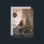 Romantic Cozy Couple Christmas Holiday Photo Card<br><div class="desc">A romantic Christmas photo card with a modern, cozy style — perfect for couples who love a dark-neutral holiday aesthetic. Soft twinkle lights, a decorated tree, and understated festive accents frame your photo with timeless charm. Replace the sample image with your own favourite portrait, personalize your names and year, and...</div>