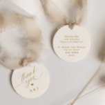 Romantic Gold and Ivory Cream Wedding Thank You Favour Tags<br><div class="desc">Elevate your wedding favours with our Round Romantic Gold and Ivory Wedding Favour Tags. These exquisite tags feature a delicate romantic script that conveys a heartfelt "thank you, " along with the loving initials of the couple, creating a personalized touch. In a harmonious blend of soft cream and shimmering gold,...</div>