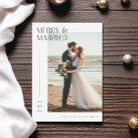 Romantic Newlywed Merry & Married Christmas Photo Holiday Card<br><div class="desc">Capture the magic of your romantic beach wedding with this chic "Merry & Married" Christmas photo holiday card. This design features a newly married couple sharing a tender moment by the ocean, bringing a coastal and tropical theme to your holiday greetings. Perfect for newlyweds, it combines elegant typography with a...</div>