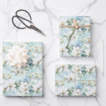 Romantic Wedding Flowers and Rings Wrapping Paper Sheet<br><div class="desc">This beautiful wedding wrapping paper is perfect for wrapping gifts for a special couple's big day. The design features delicate white wedding flowers, symbolizing purity and love, elegantly arranged against a soft blue background. Adding to the charm are gold wedding rings, representing the eternal commitment made by the couple, intertwined...</div>