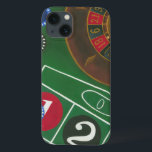 Roulette Table with Chips and Wheel iPhone 13 Case<br><div class="desc">The spinning wheel holds all the power on the roulette table, but the power of this painting is in the lifelike depiction of a casino scene. The green of the felt and the colour of the chips puts you at the table, waiting on your bet to pay off. Be sure...</div>