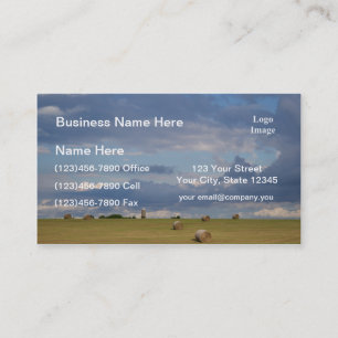 Round bales in a field by silo. business card
