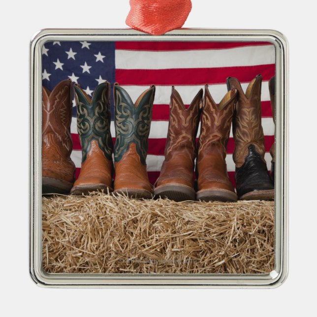 Row of cowboy boots on haystack metal ornament (Front)