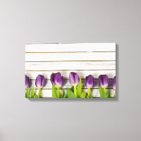 row of purple tulips on wood