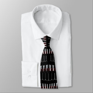 Row of wine glasses with red wine on black tie