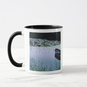 Rowboat on small lake surrounded by water mug