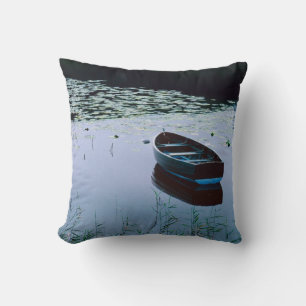 Rowboat on small lake surrounded by water throw pillow
