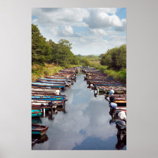 rowing boats moored at ross castle in killarney co poster