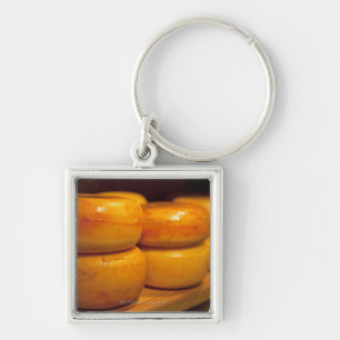 rows of colourful yellow Edam cheeses lined up Keychain
