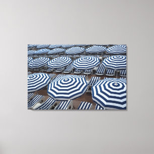 Rows Of Striped Beach Umbrellas With Sun Beds Canvas Print