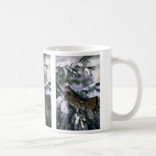 Ruffed grouse perched in a snowy tree coffee mug
