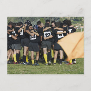 Rugby team standing in a circle postcard