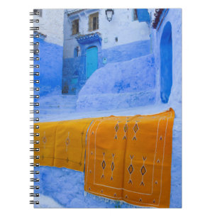 Rugs Draped On A Blue Wall Notebook