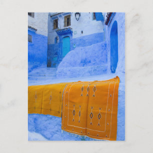 Rugs Draped On A Blue Wall Postcard