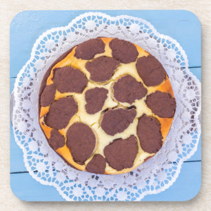 Russian chocolate cheesecake on a blue wooden back coaster